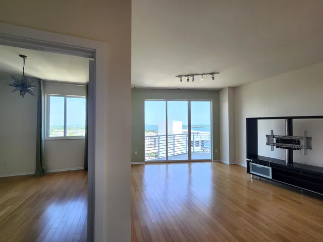 a view of a room with wooden floor and window