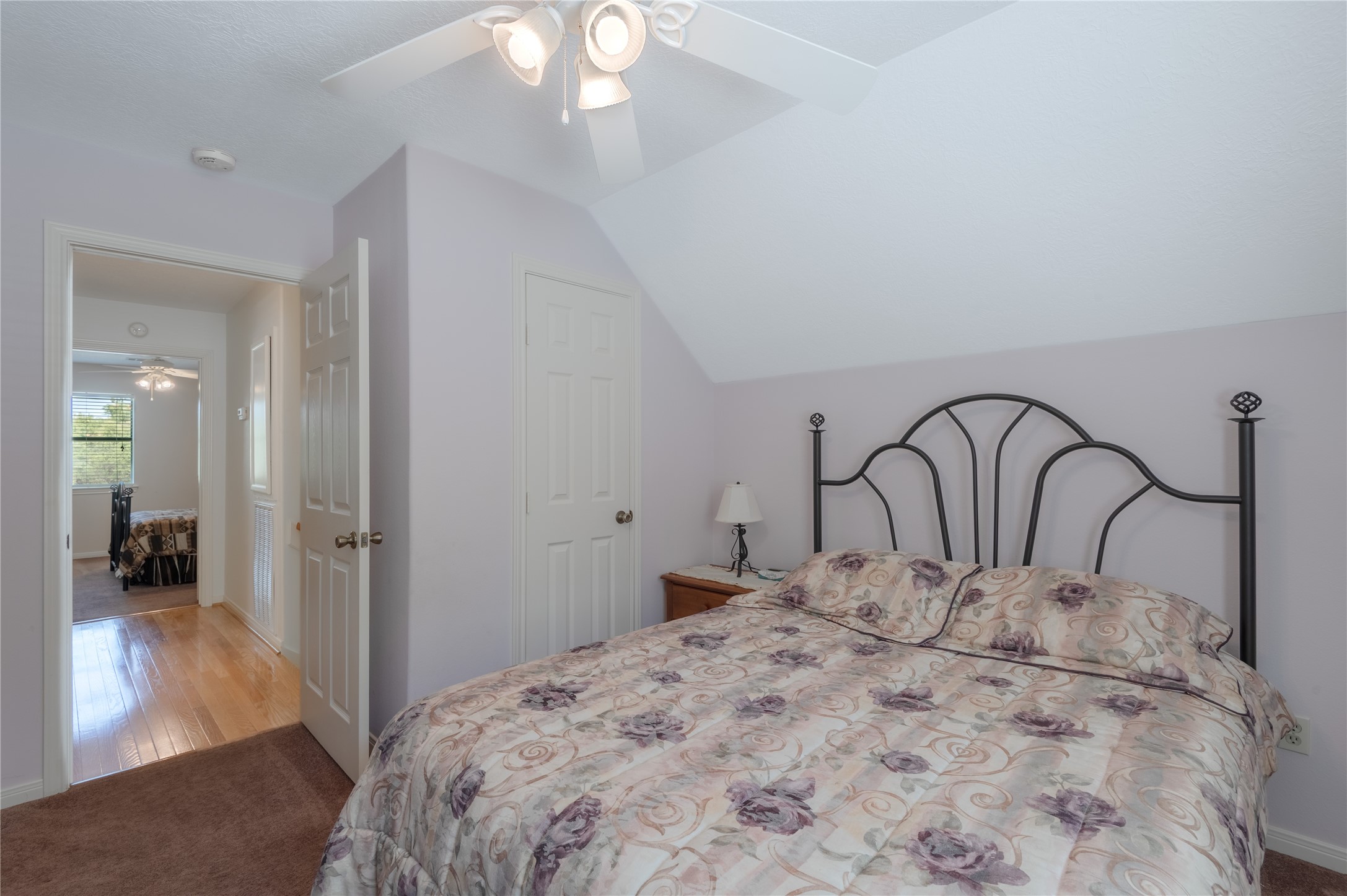 15 Lake Side Trinity, TX 75862 - Photo 23 of 33 a bedroom with a large bed and a chandelier