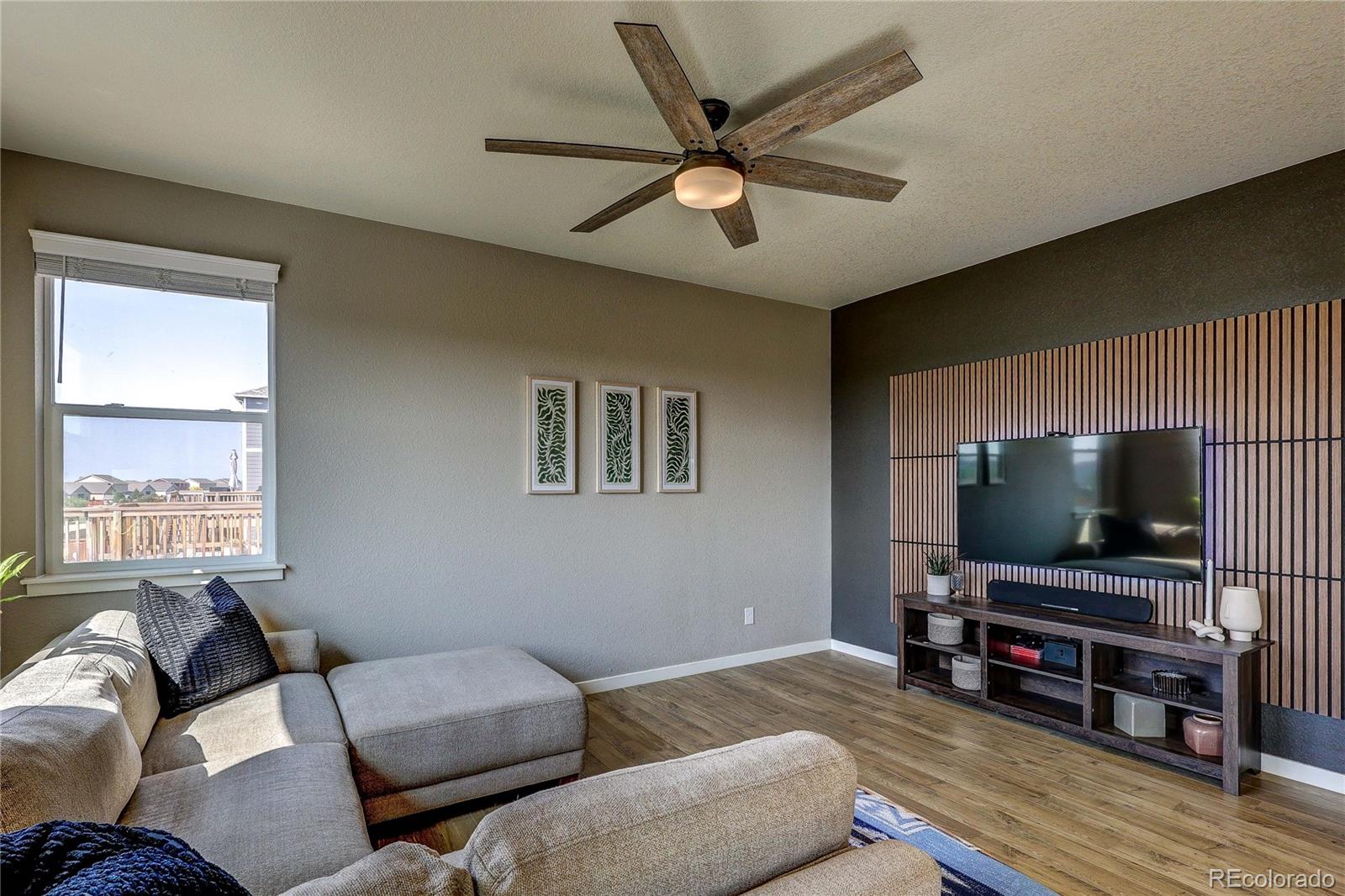 1335 Copeland Falls Road Severance, CO 80550 - Photo 19 of 48 a living room with furniture and a flat screen tv