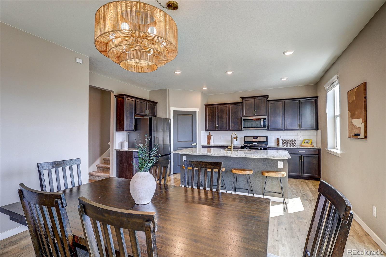 1335 Copeland Falls Road Severance, CO 80550 - Photo 20 of 48 a large kitchen with a table and chairs