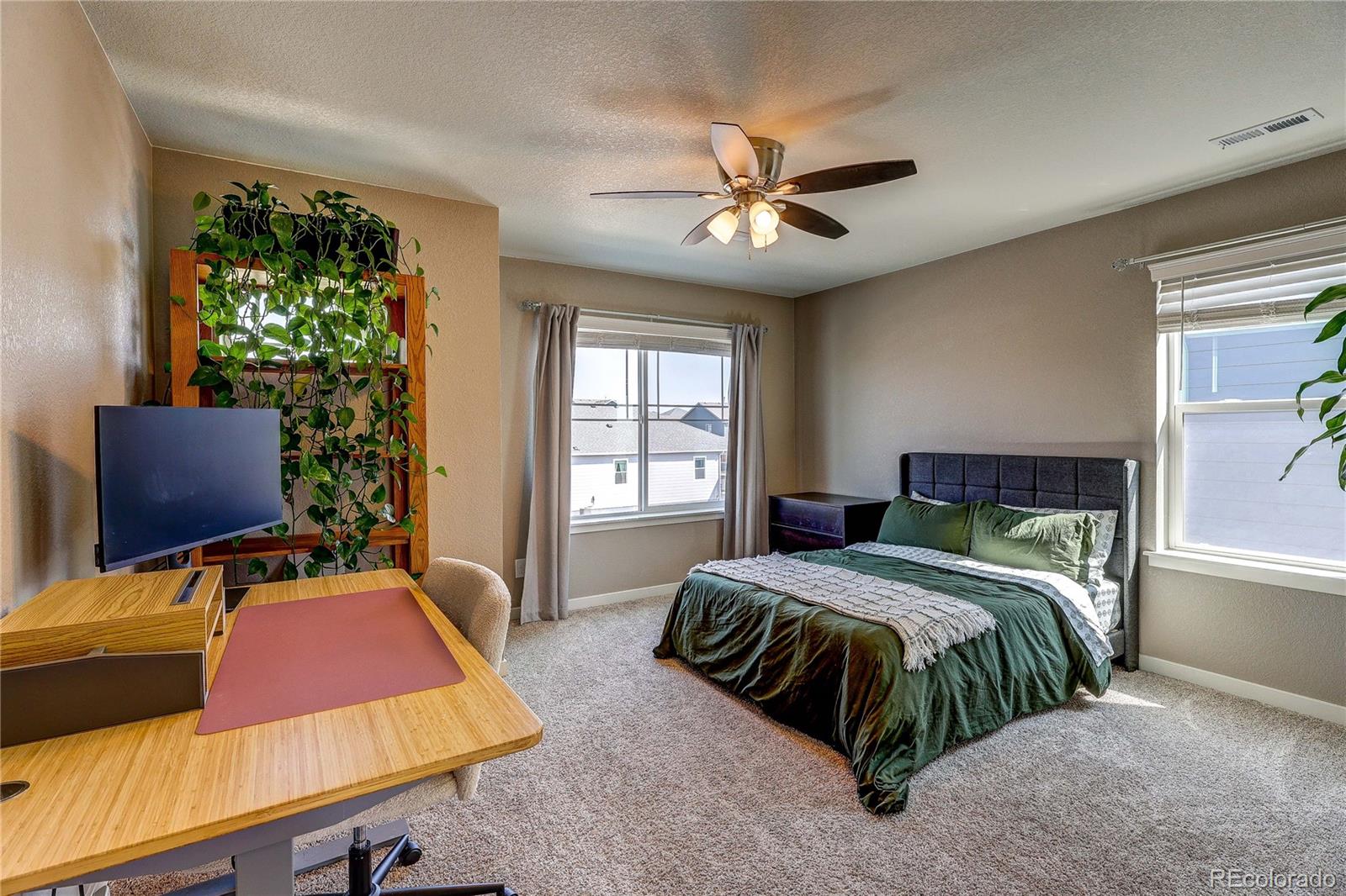 1335 Copeland Falls Road Severance, CO 80550 - Photo 23 of 48 a bedroom with a large bed and a chandelier