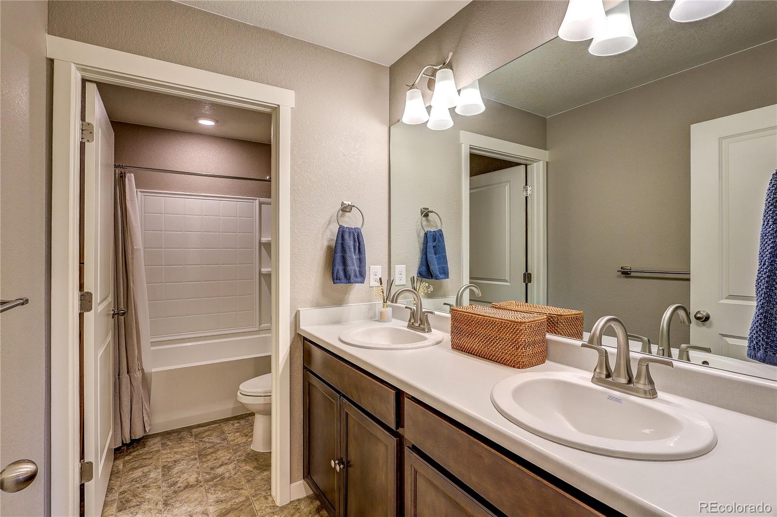 1335 Copeland Falls Road Severance, CO 80550 - Photo 25 of 48 a bathroom with a granite countertop sink a toilet and a mirror