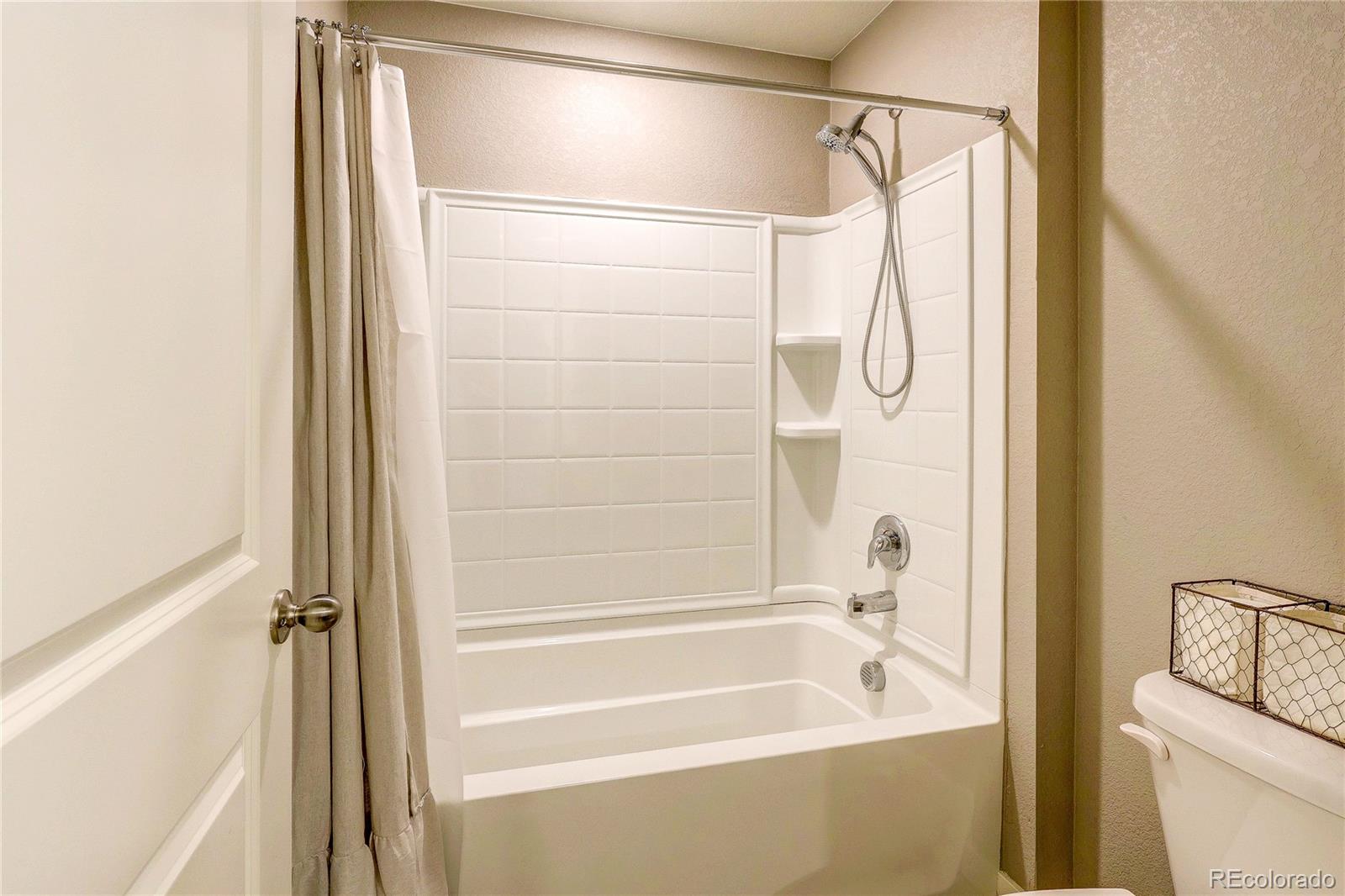 1335 Copeland Falls Road Severance, CO 80550 - Photo 26 of 48 a bathroom with a bathtub and a shower