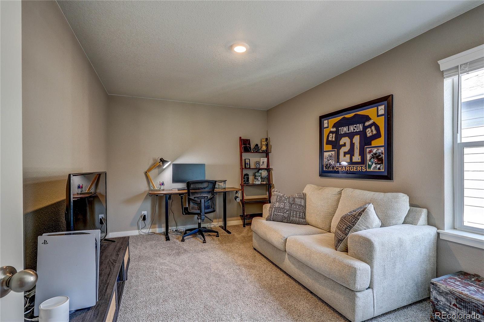 1335 Copeland Falls Road Severance, CO 80550 - Photo 28 of 48 a living room with furniture and a flat screen tv