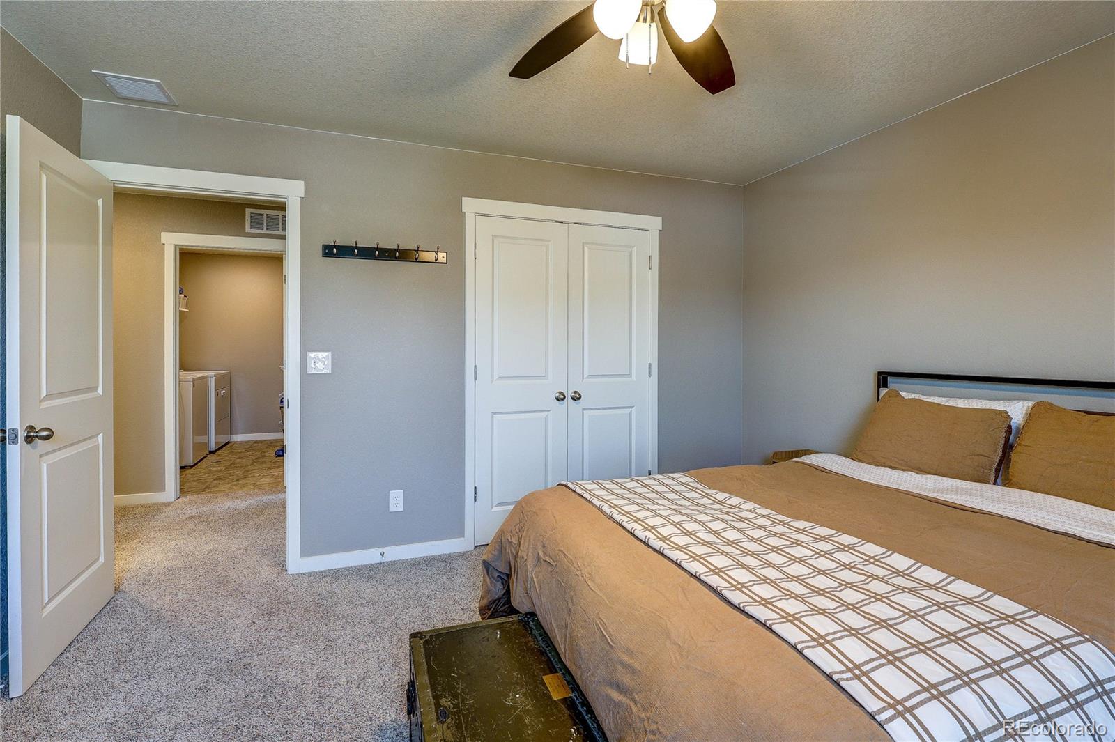 1335 Copeland Falls Road Severance, CO 80550 - Photo 31 of 48 a bedroom with a bed and a chandelier