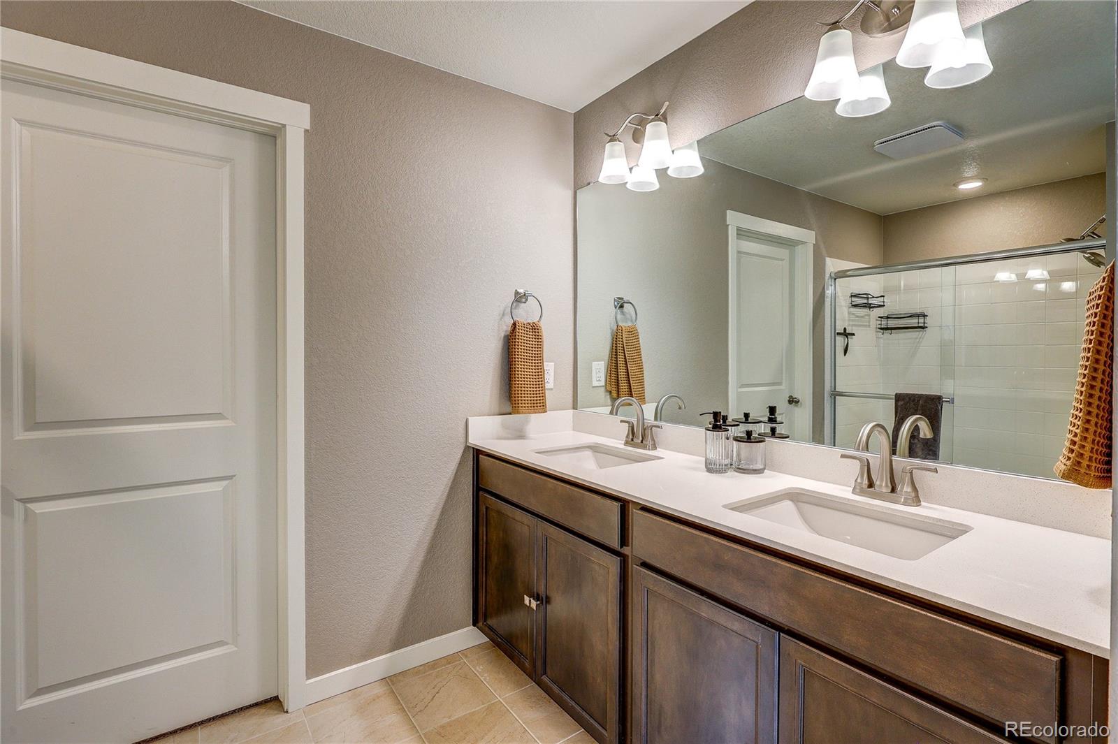 1335 Copeland Falls Road Severance, CO 80550 - Photo 35 of 48 a bathroom with a double vanity sink and a mirror