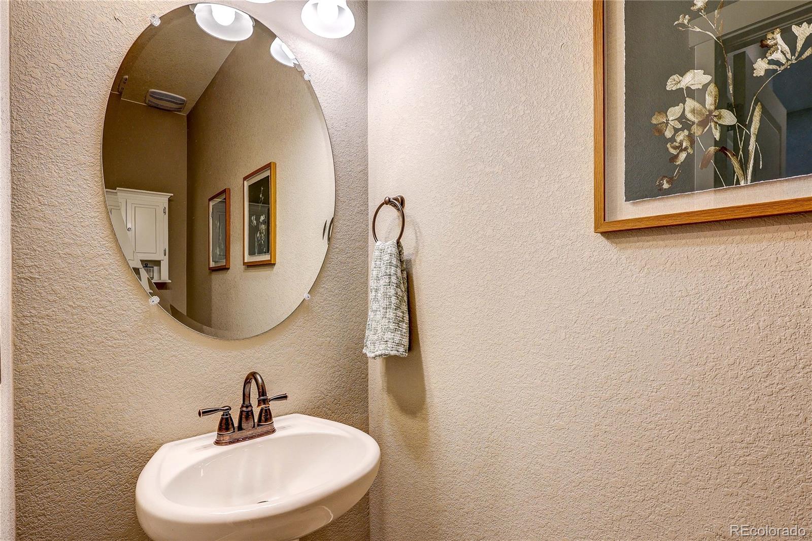 1335 Copeland Falls Road Severance, CO 80550 - Photo 9 of 48 a bathroom with a sink and mirror