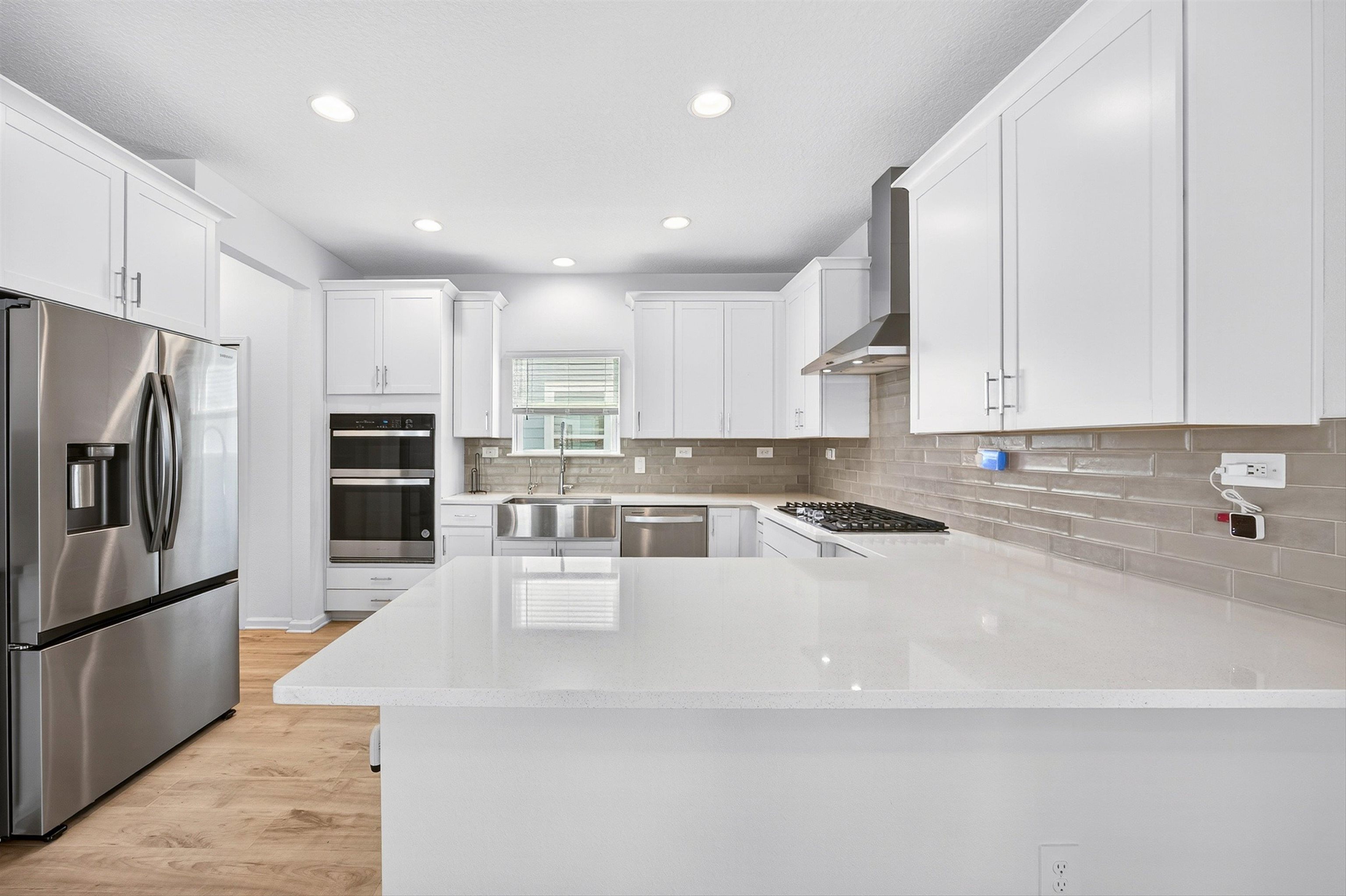 168 Torres Trace St. Augustine, FL 32095 - Photo 11 of 50 a large kitchen with kitchen island a large counter top stainless steel appliances and cabinets