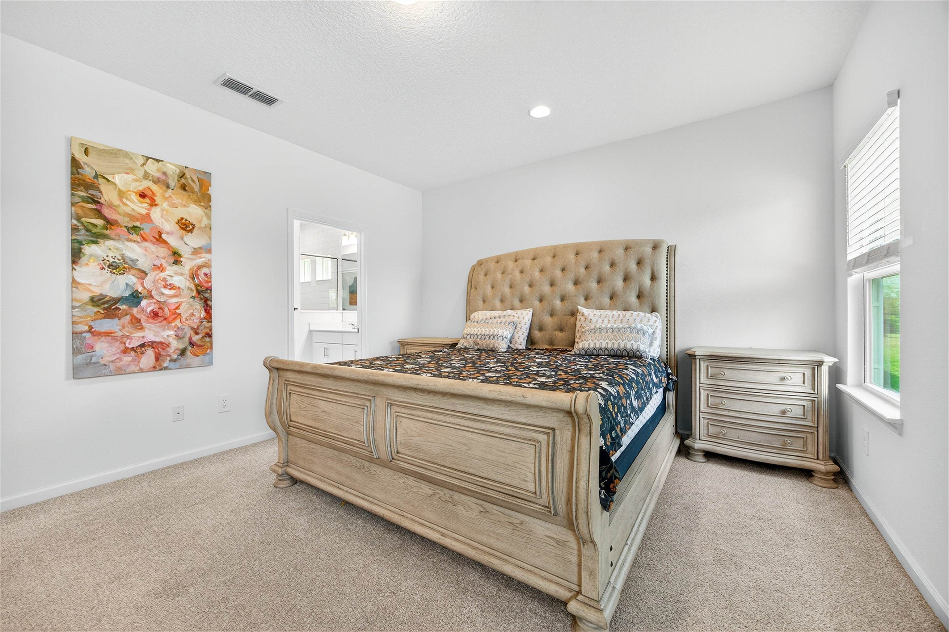 168 Torres Trace St. Augustine, FL 32095 - Photo 14 of 50 a bed sitting in a bedroom next to a window