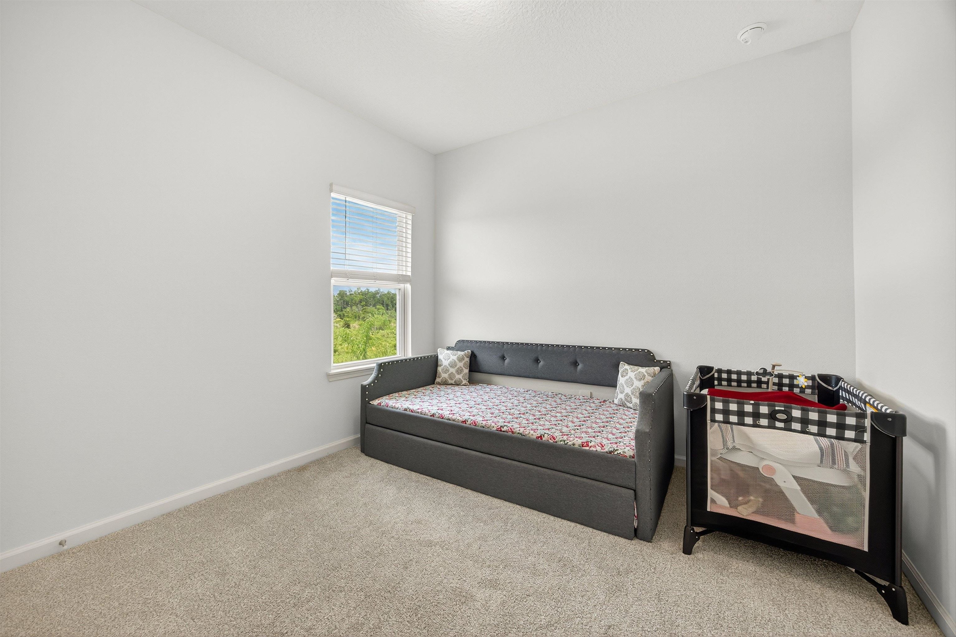 168 Torres Trace St. Augustine, FL 32095 - Photo 27 of 50 a bedroom with a bed and a window