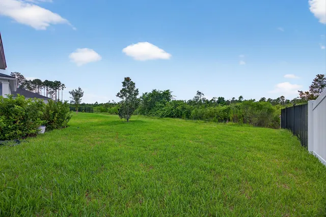 a view of a porch with furniture and garden