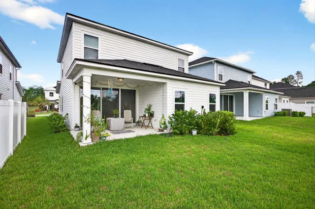 a two chairs sitting in front of a house