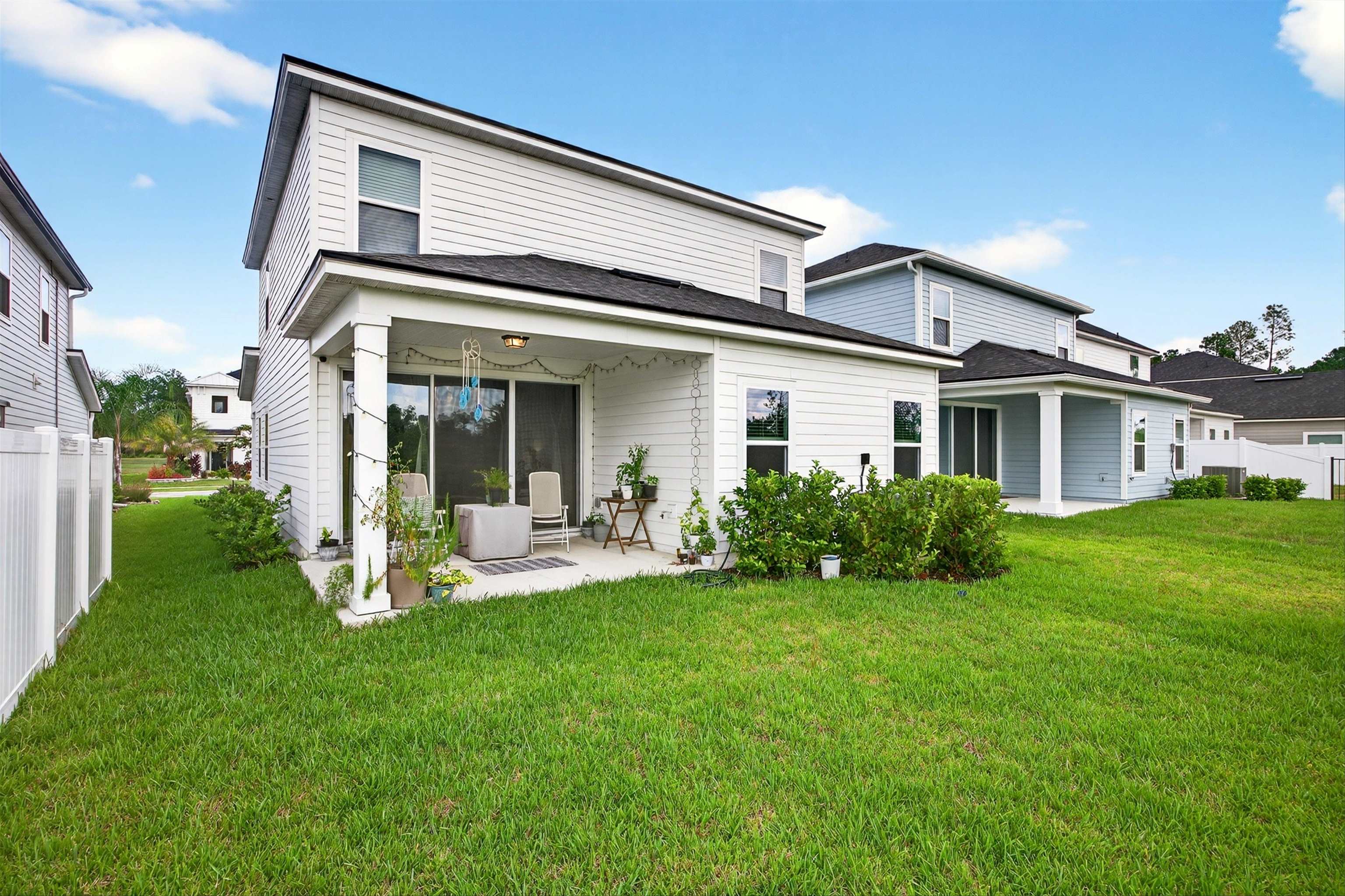 168 Torres Trace St. Augustine, FL 32095 - Photo 32 of 50 a front view of a house with a yard and porch
