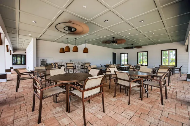 an aerial view of a pool patio fire pit and outdoor seating