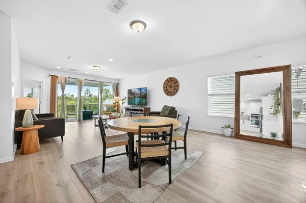 a view of a dining room with furniture and wooden floor