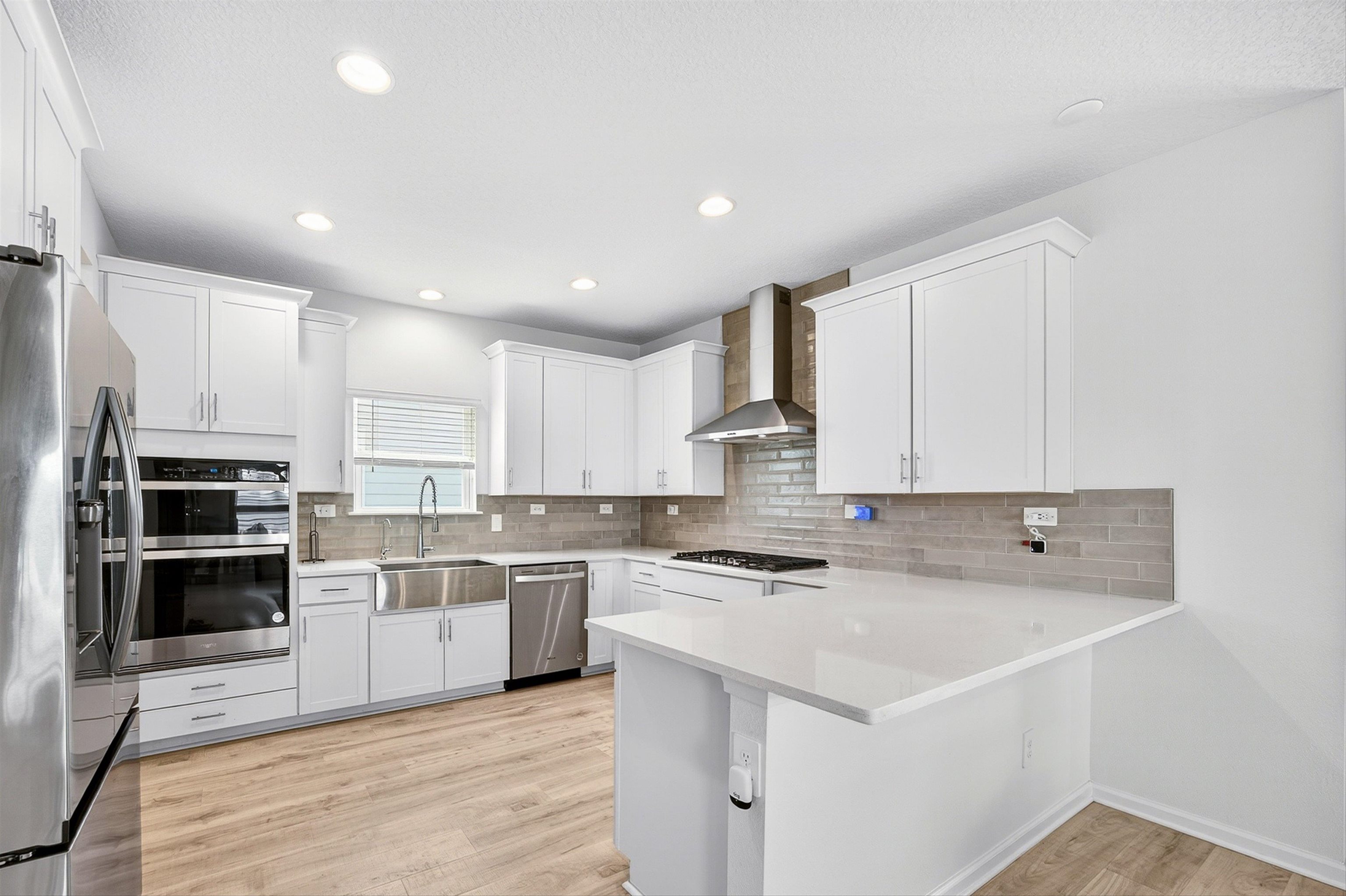 168 Torres Trace St. Augustine, FL 32095 - Photo 9 of 50 a kitchen with a sink a counter top space stainless steel appliances and cabinets