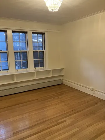 a view of a room with wooden floor and windows