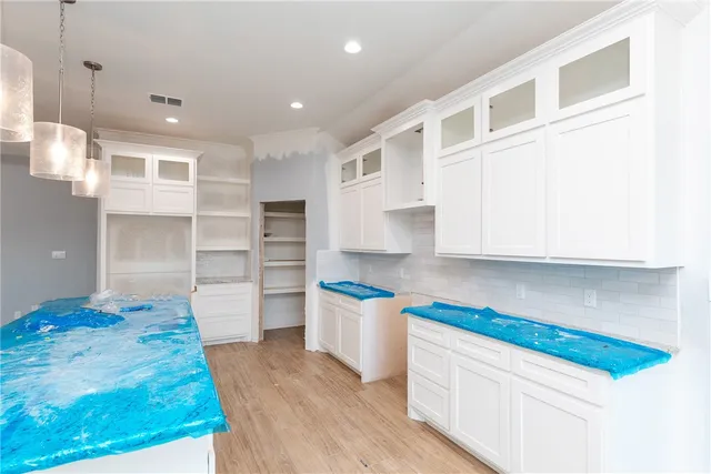 a kitchen with refrigerator and cabinets