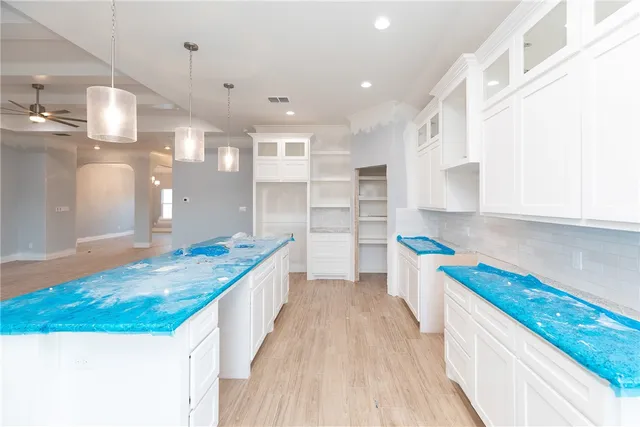 a kitchen with a sink stove and wooden cabinets