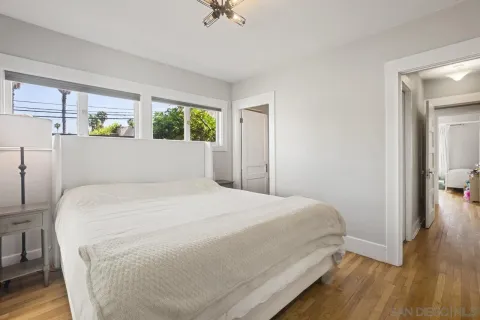 a large bed sitting in a bedroom next to a window