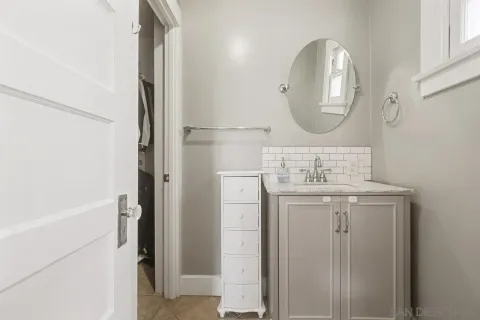 a bathroom with a sink a mirror and a shower