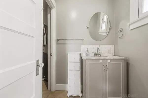 a bathroom with a sink a mirror and a shower