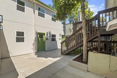 a view of a house with a yard and deck