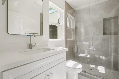 a kitchen with stainless steel appliances a refrigerator sink and cabinets