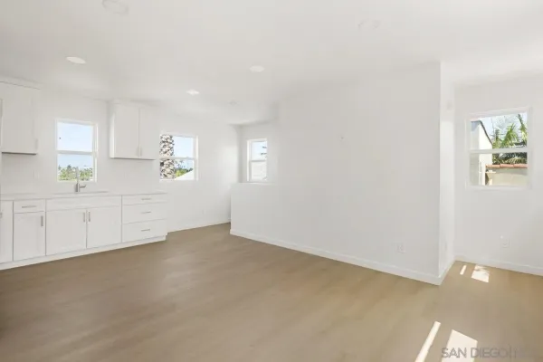 a view of a kitchen with a sink a refrigerator and window