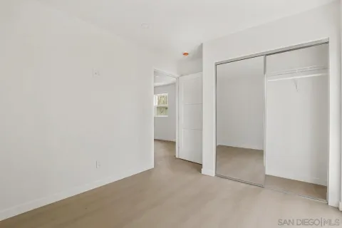 a bedroom with a bed and a mirror