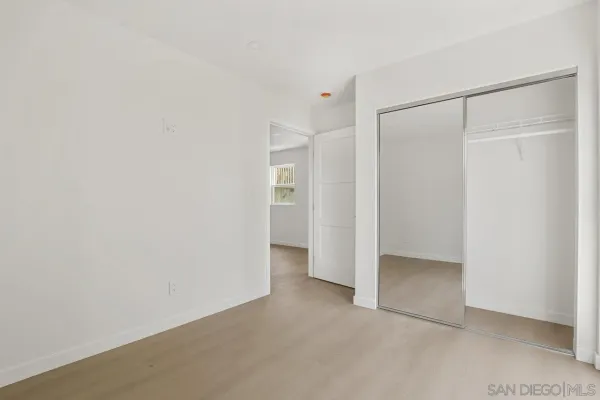 a bedroom with a bed and a mirror