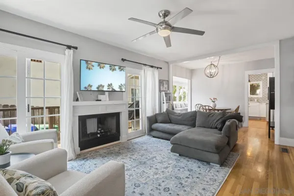 a living room with furniture a large window and a fireplace