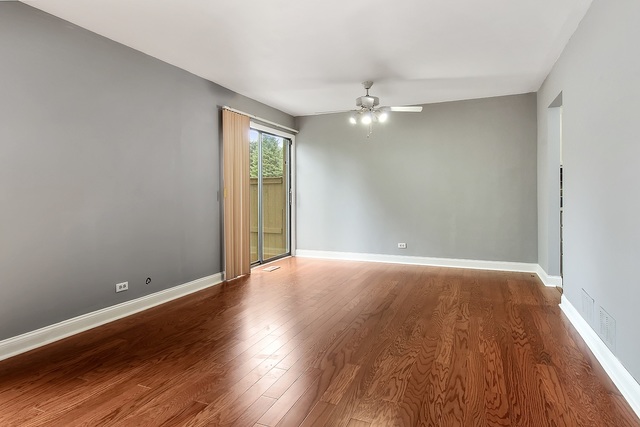 800 Oregon Trail Roselle, IL 60172 - Photo 2 of 16 wooden floor in an empty room with a window