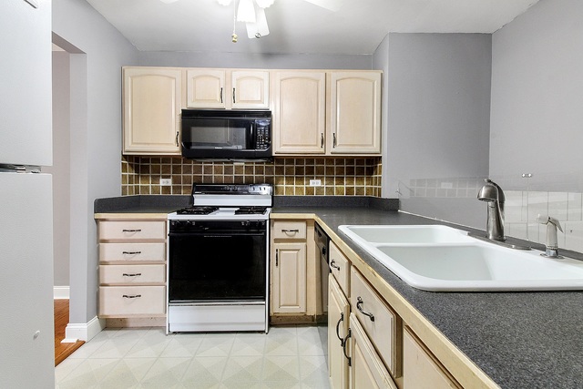 800 Oregon Trail Roselle, IL 60172 - Photo 3 of 16 a kitchen with stainless steel appliances granite countertop a sink and a stove