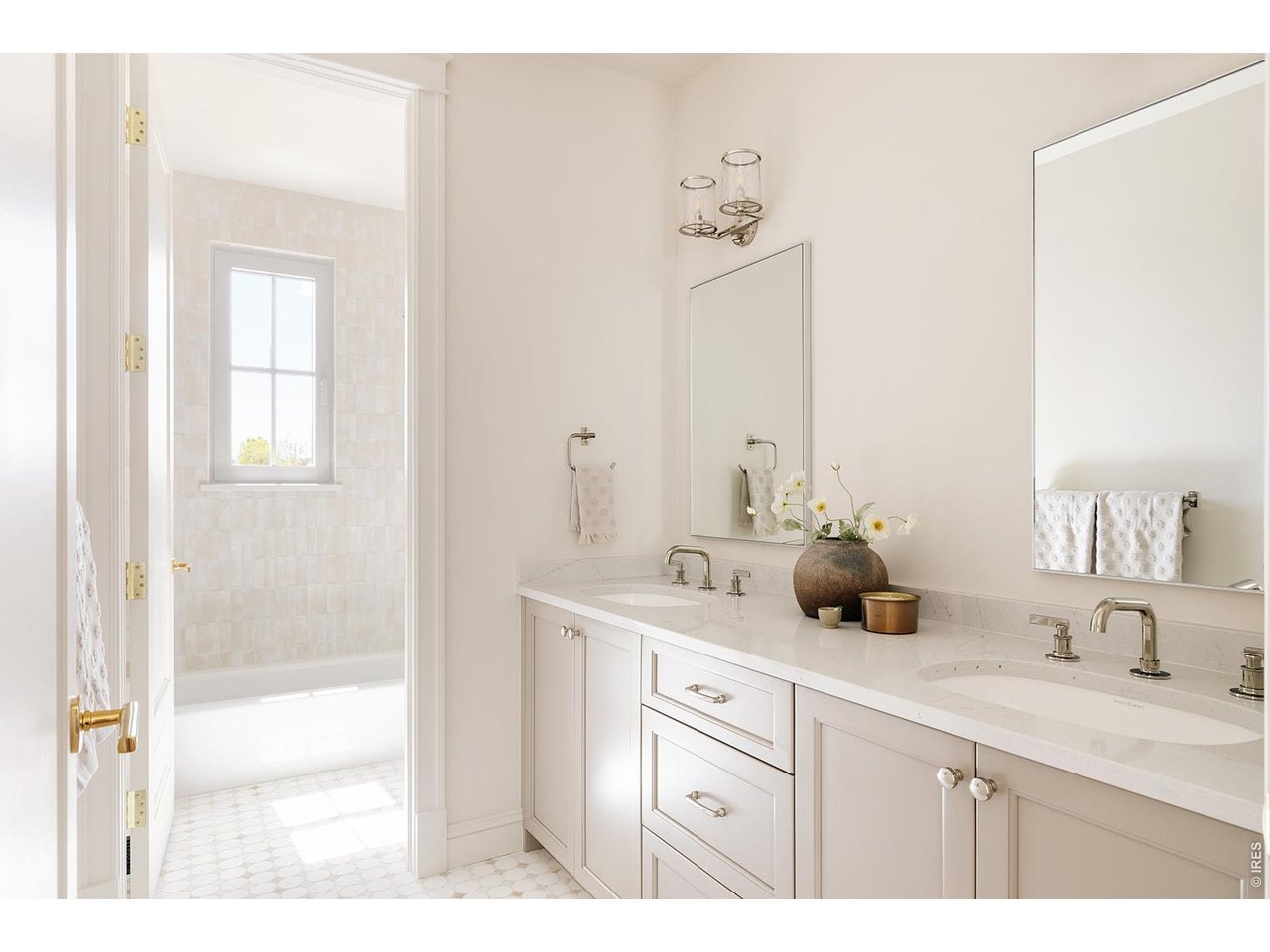 918 Cub Court Fort Collins, CO 80525 - Photo 23 of 45 a bathroom with double vanity sink a mirror and a
