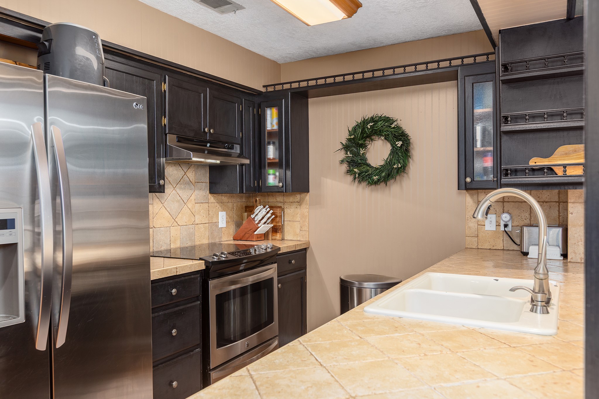 175 County Road 2005 Liberty, TX 77575 - Photo 13 of 42 a kitchen with stainless steel appliances granite countertop a refrigerator and a sink