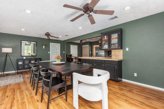 a bed room with a bed and a ceiling fan