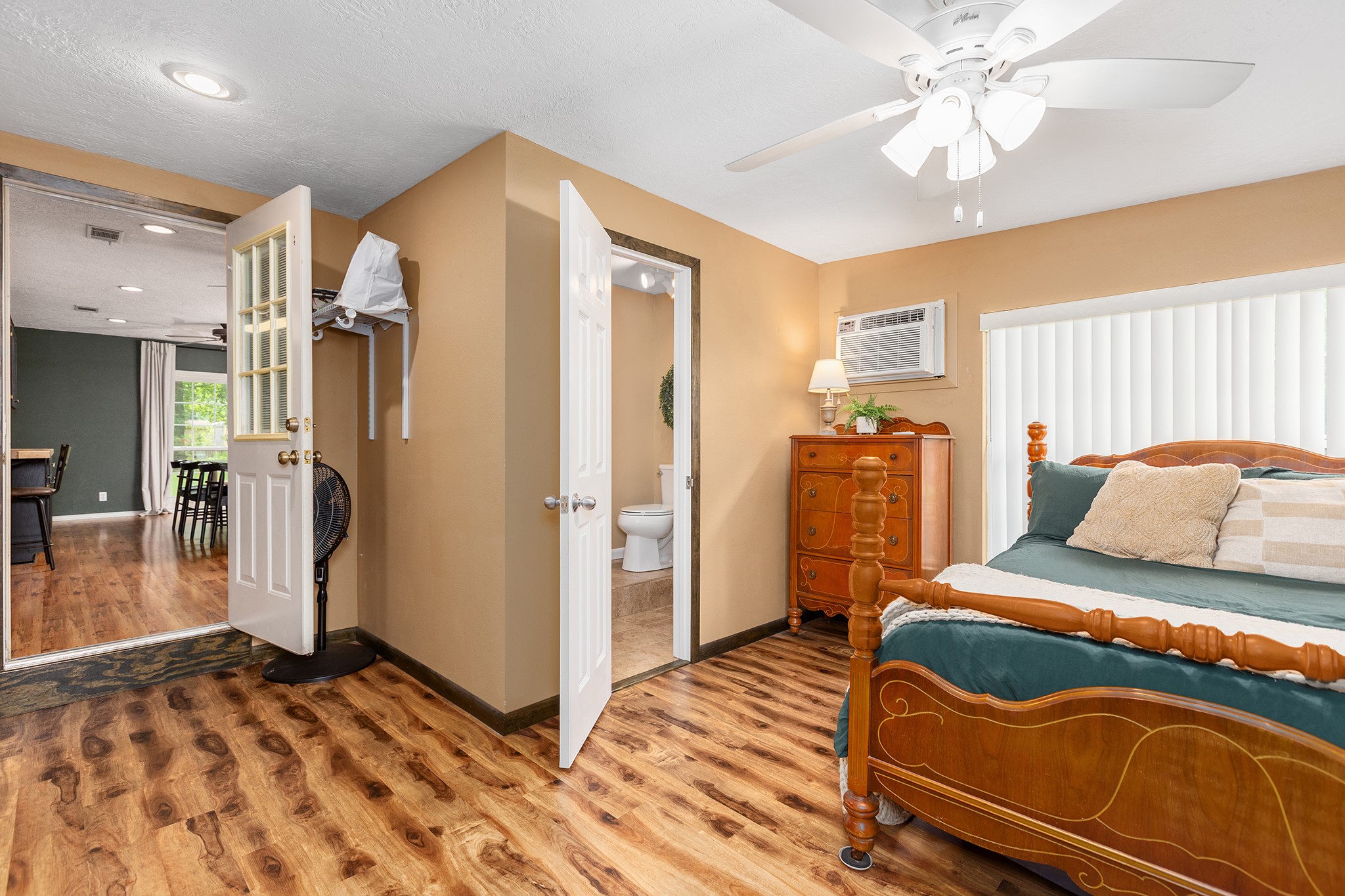175 County Road 2005 Liberty, TX 77575 - Photo 19 of 42 a bedroom with a bed and a chandelier