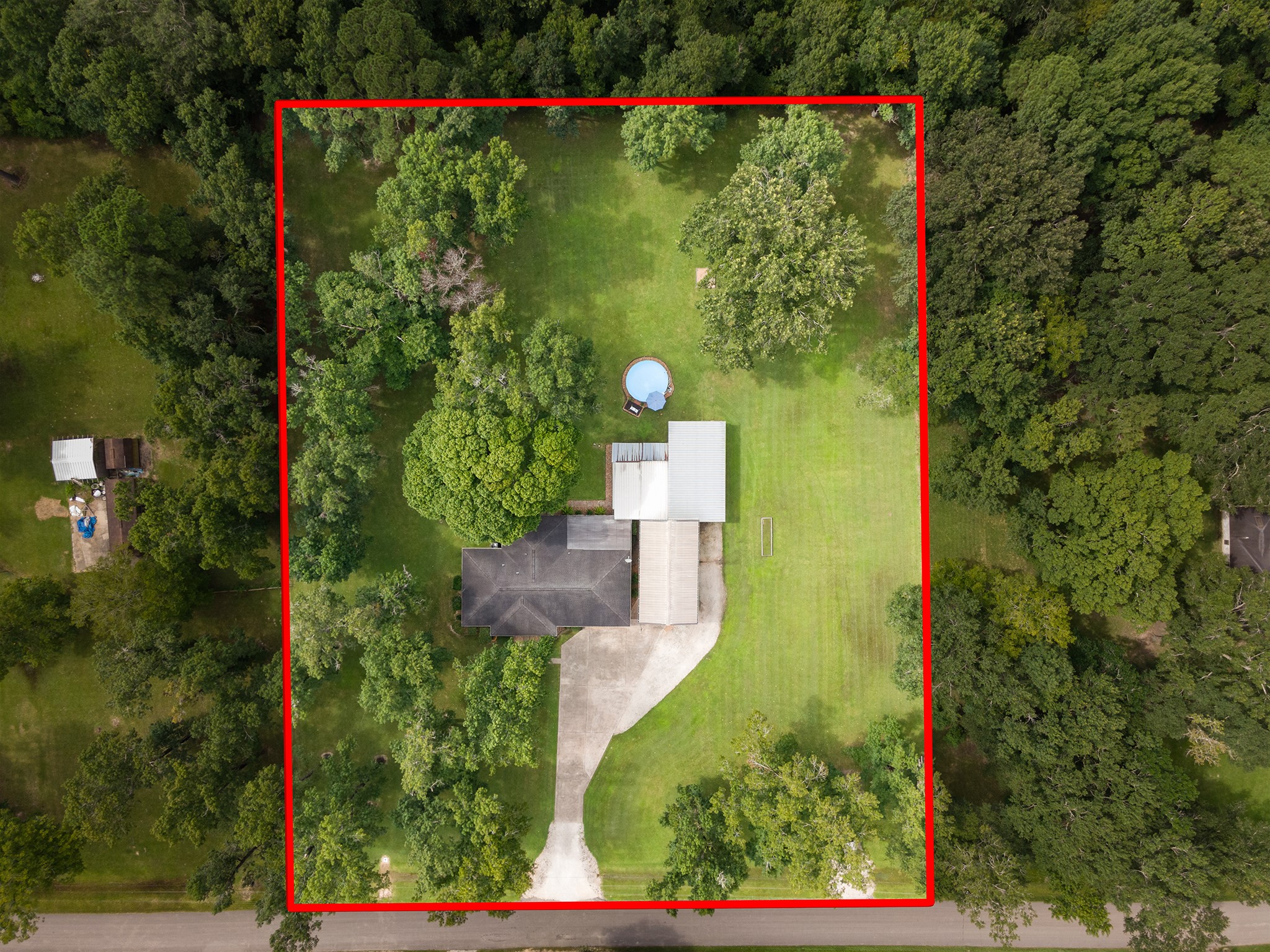 175 County Road 2005 Liberty, TX 77575 - Photo 2 of 42 an aerial view of a house with a yard and garden