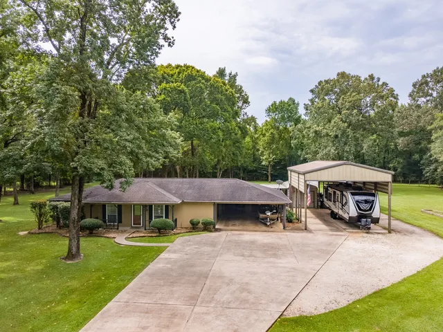 a view of a house with a yard and sitting area