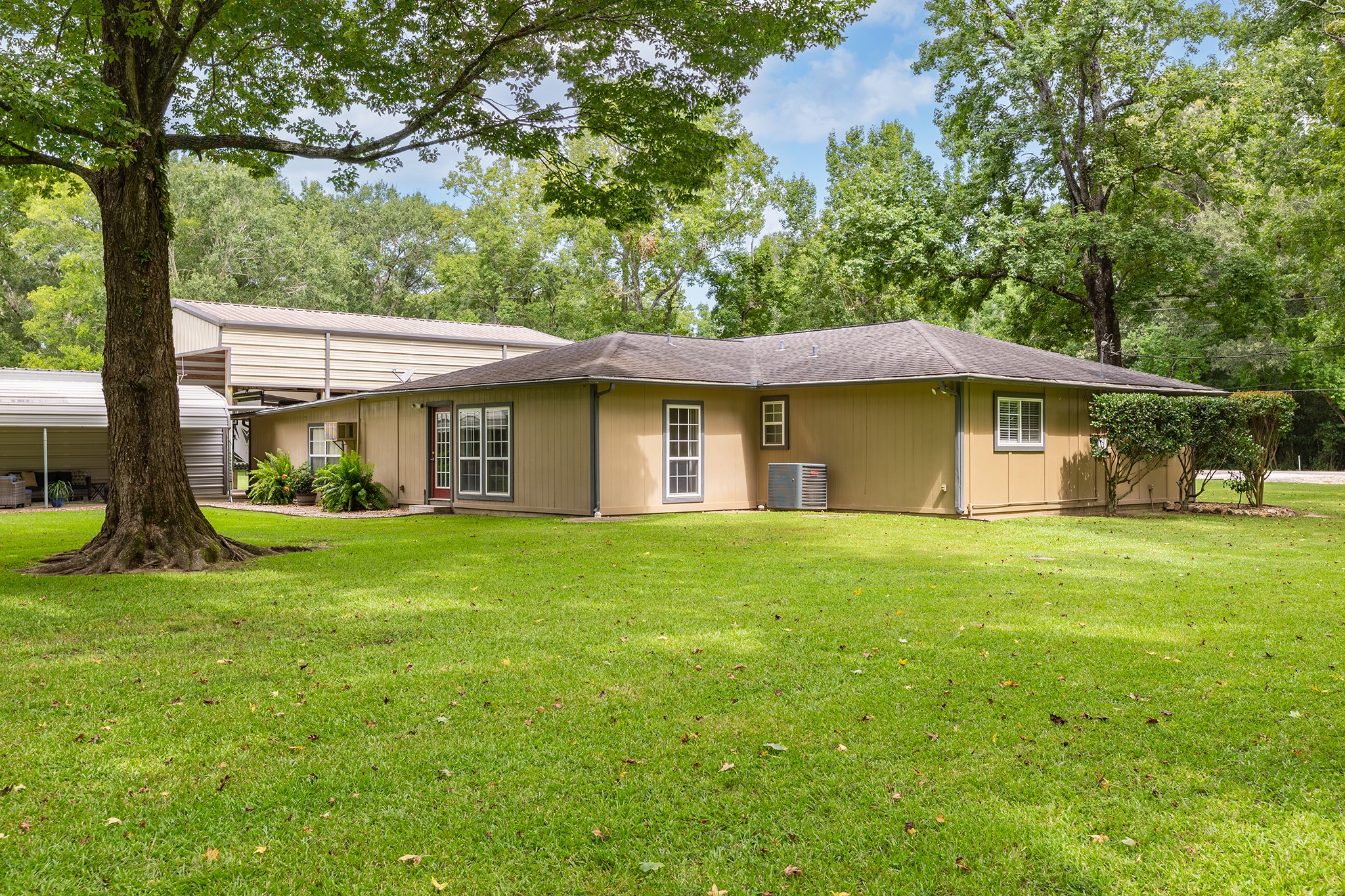 175 County Road 2005 Liberty, TX 77575 - Photo 38 of 42 a view of a big house with a big yard and large trees