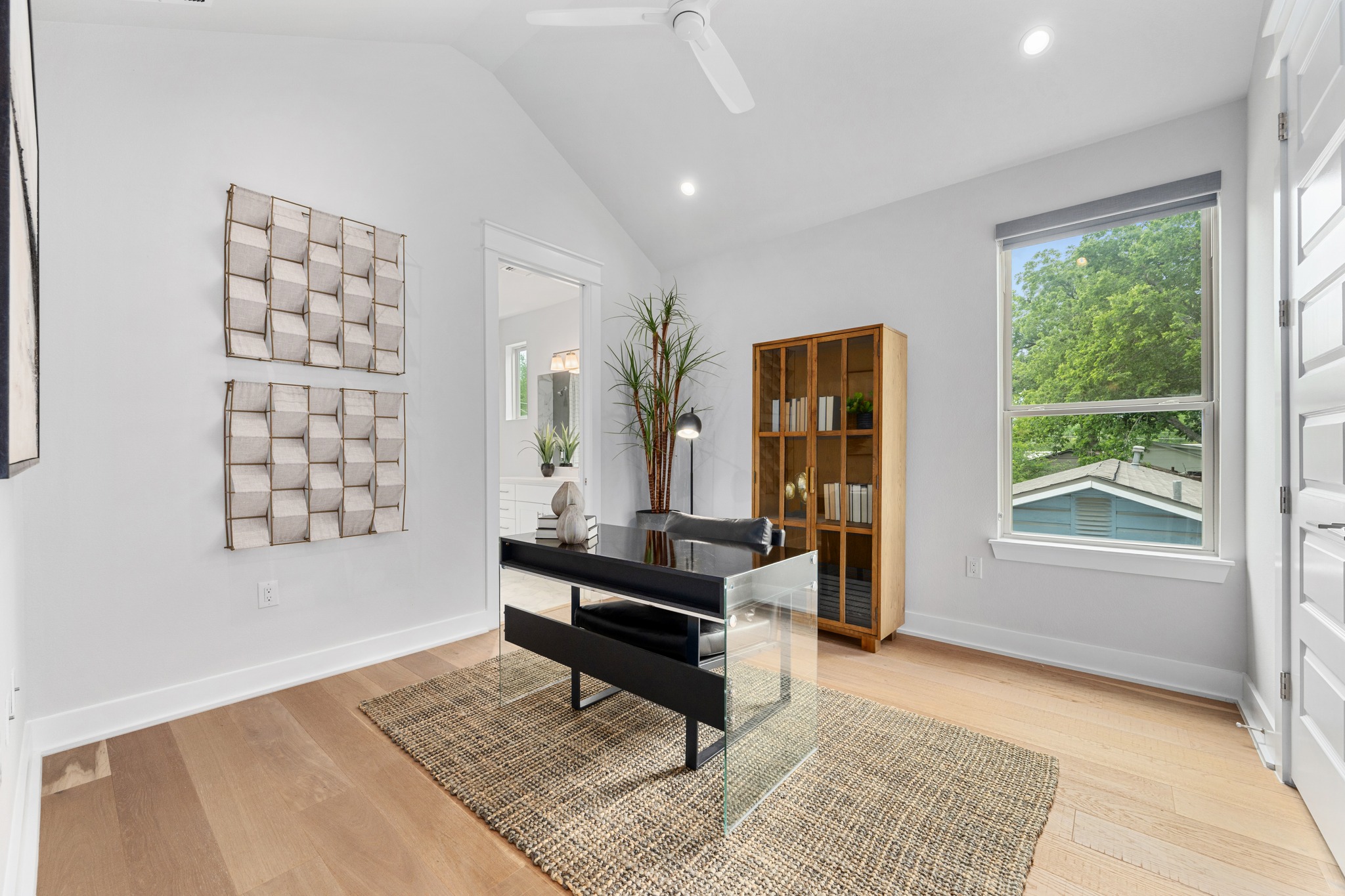 1409 Alegria Road, Unit A Austin, TX 78757 - Photo 17 of 24 An airy office space features vaulted ceilings, rich hardwood floors, and a bright window vista.