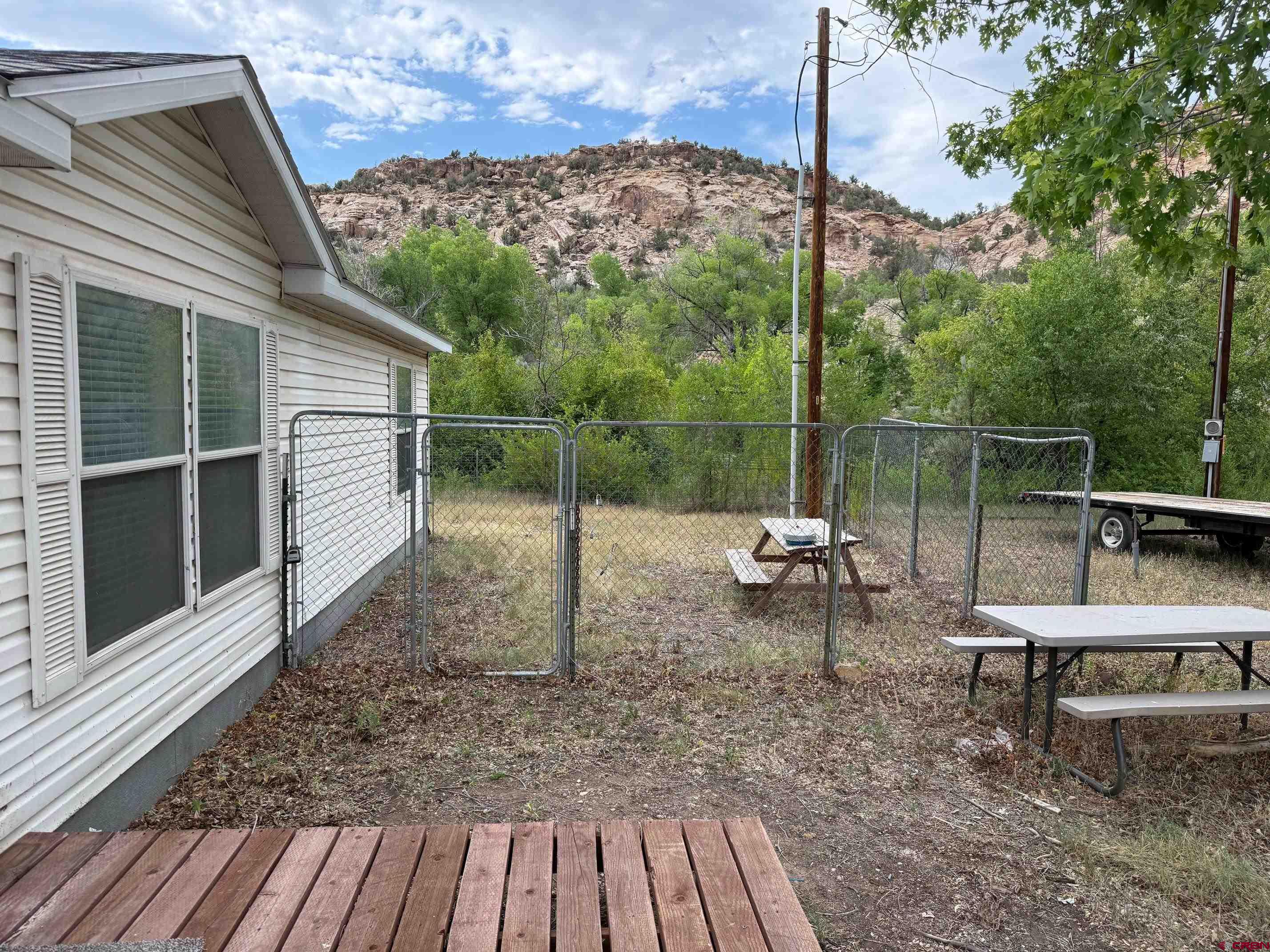 440 Park Drive Naturita, CO 81422 - Photo 1 of 18 a backyard of a house with table and chairs