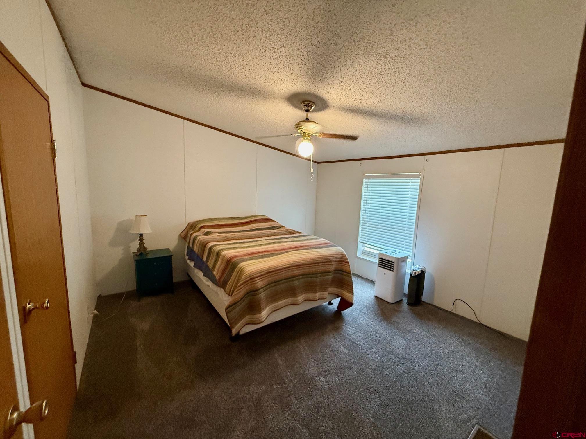 440 Park Drive Naturita, CO 81422 - Photo 13 of 18 a spacious bedroom with a bed and a window