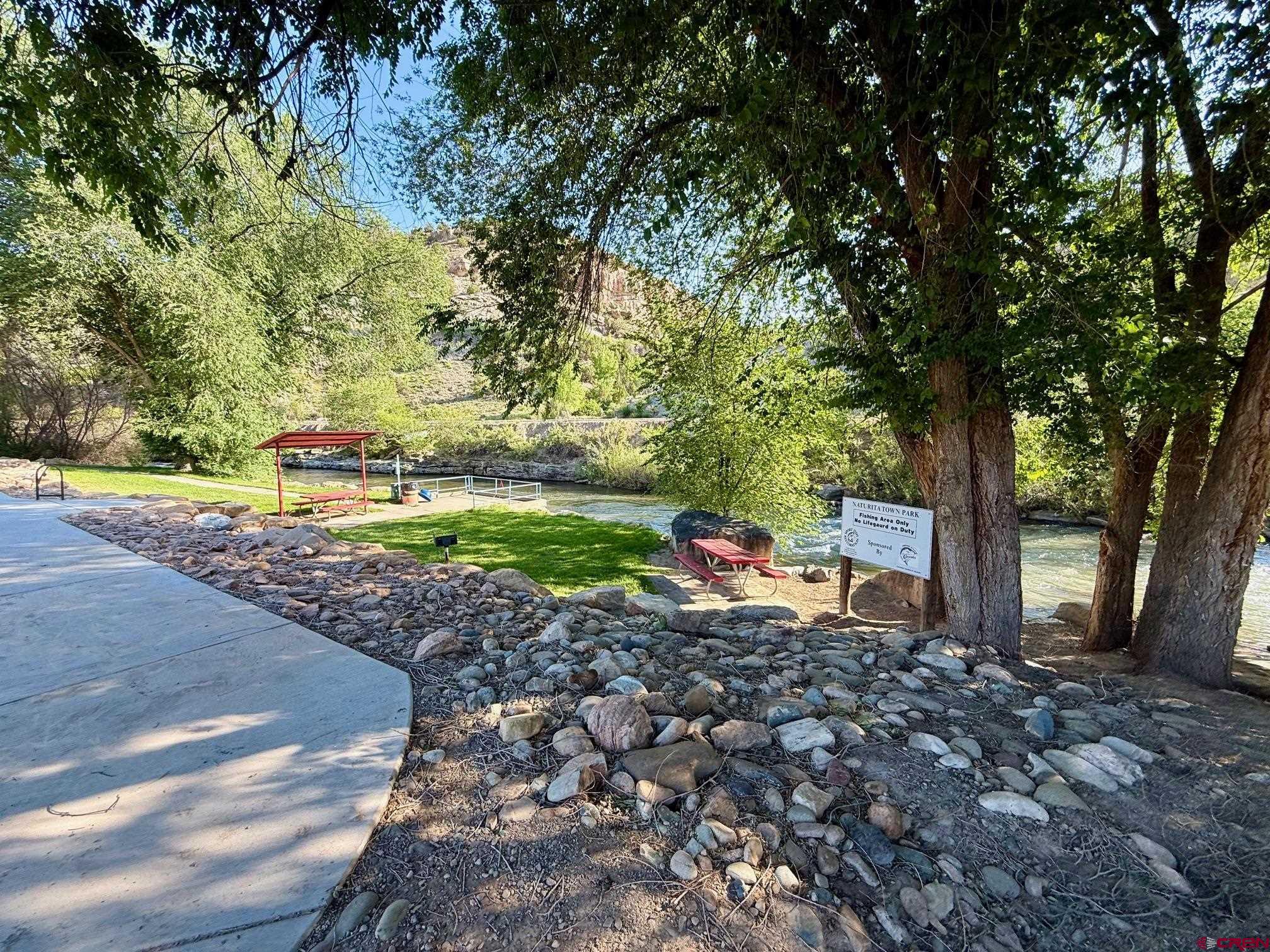 440 Park Drive Naturita, CO 81422 - Photo 18 of 18 a row of a table and chairs in a backyard