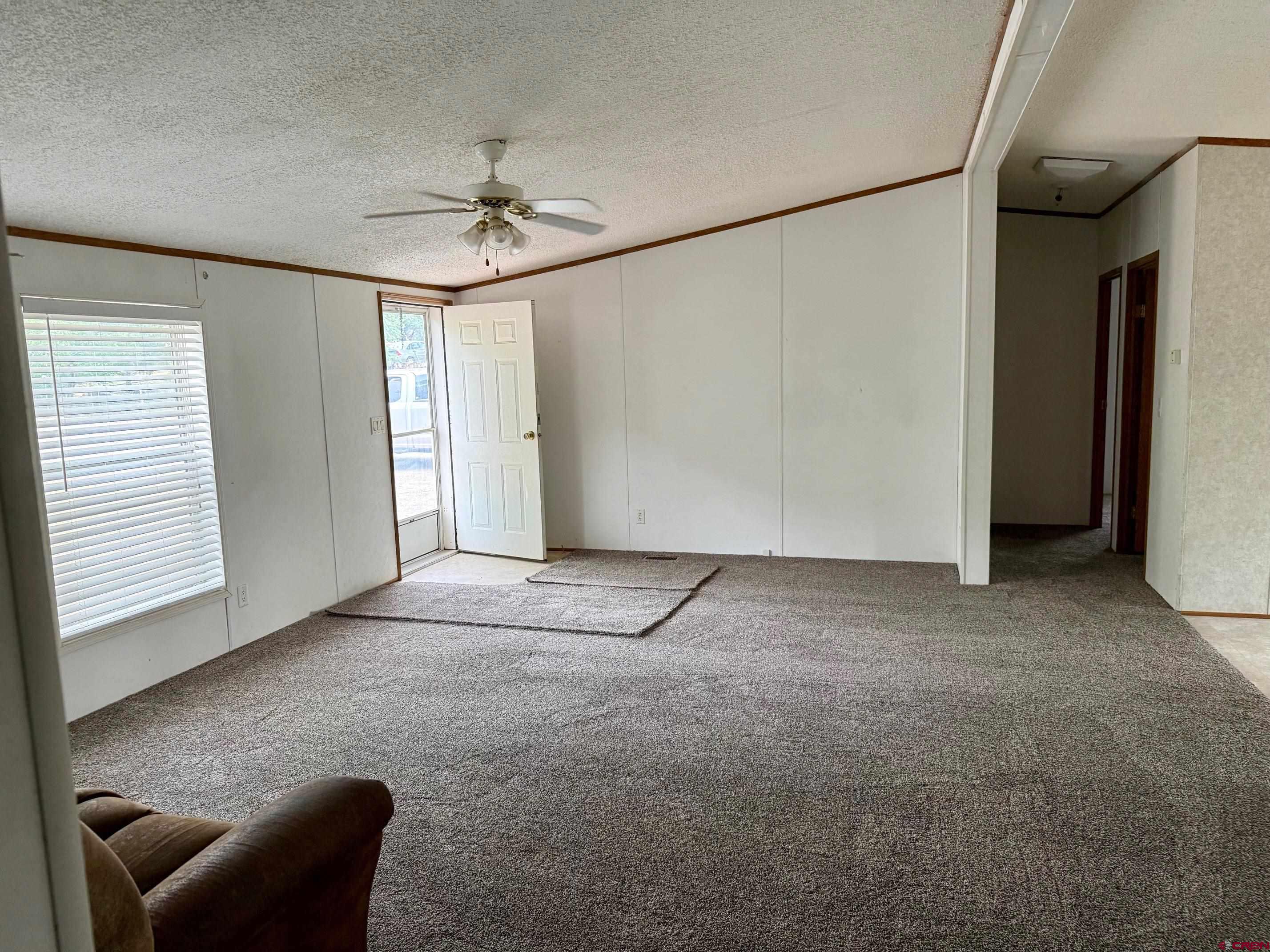 440 Park Drive Naturita, CO 81422 - Photo 4 of 18 an empty room with windows and fan