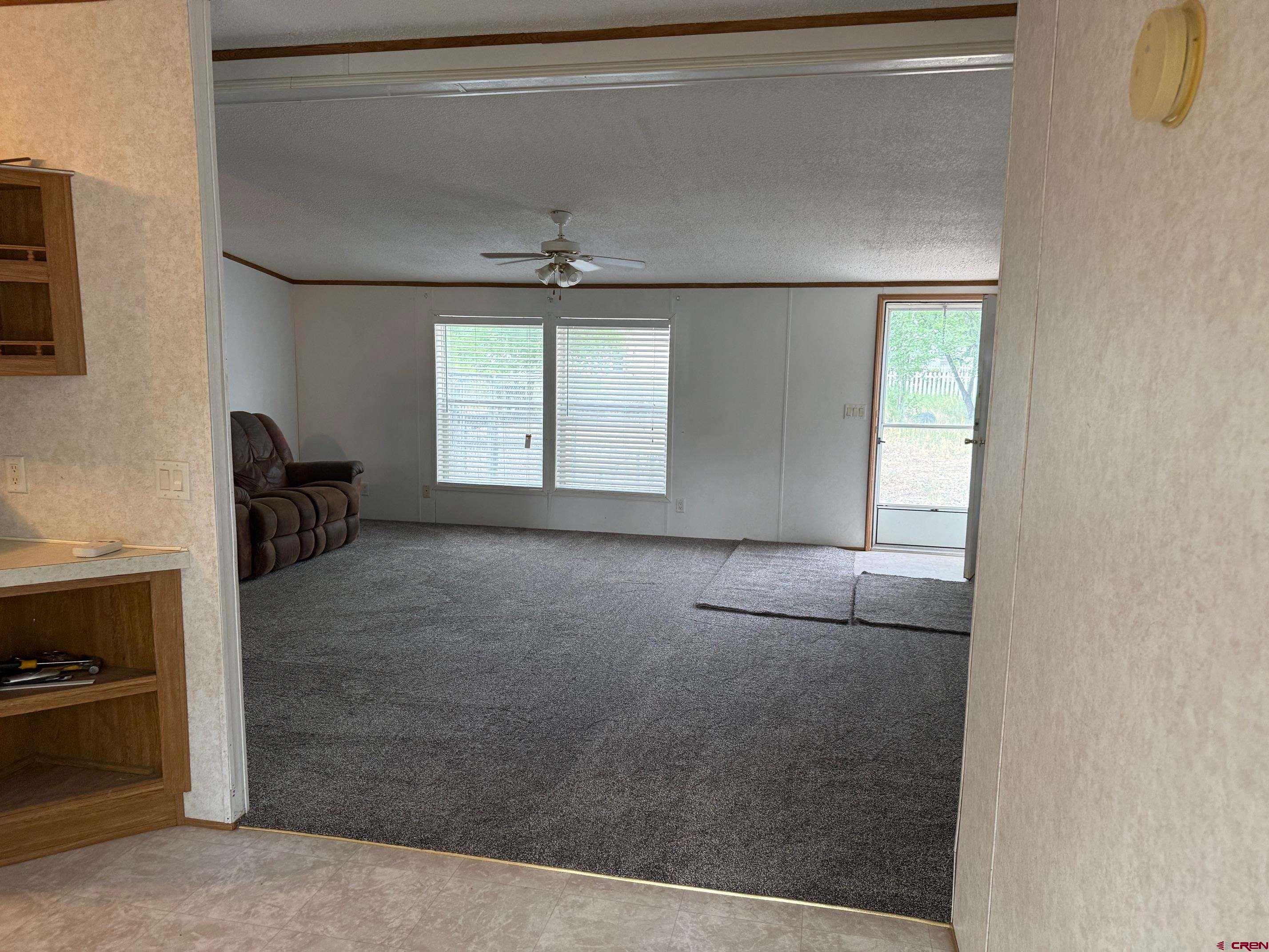 440 Park Drive Naturita, CO 81422 - Photo 6 of 18 a view of empty room with wooden floor and fan