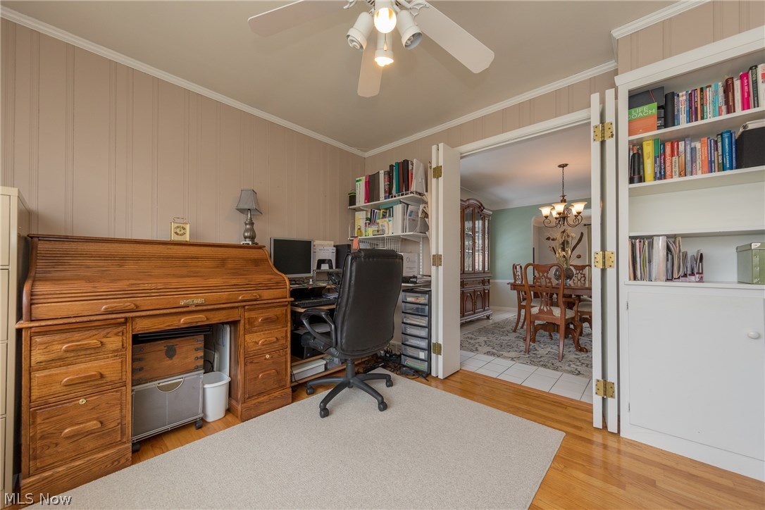 2432 Saybrook Road Cleveland, OH 44118 - Photo 17 of 32 The Sun Room with hardwood floor and built-in cabinetry with library display shelves