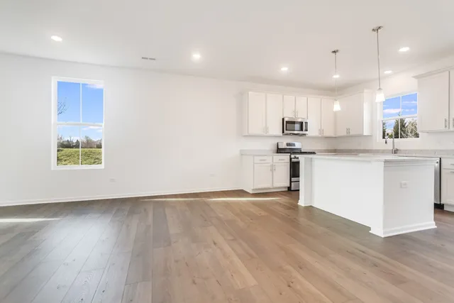 a view of kitchen with wooden floor and window