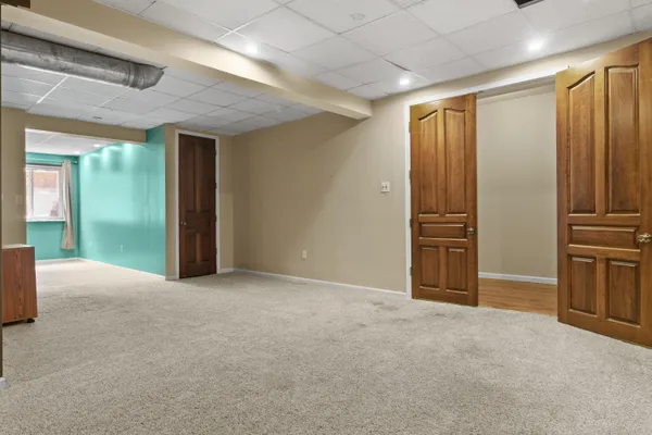 an empty room with furniture and a hallway